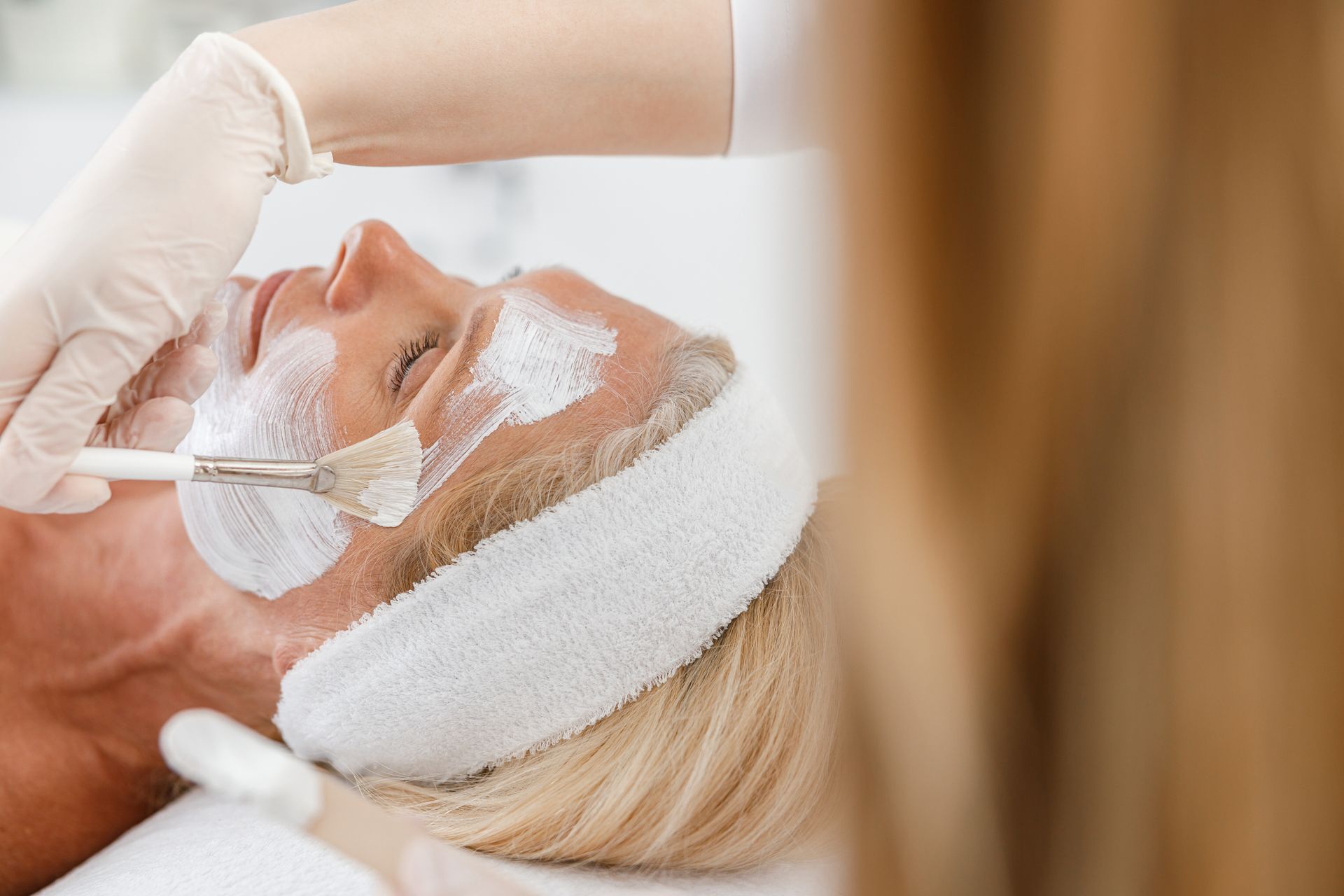 A woman is getting a facial treatment at a spa.