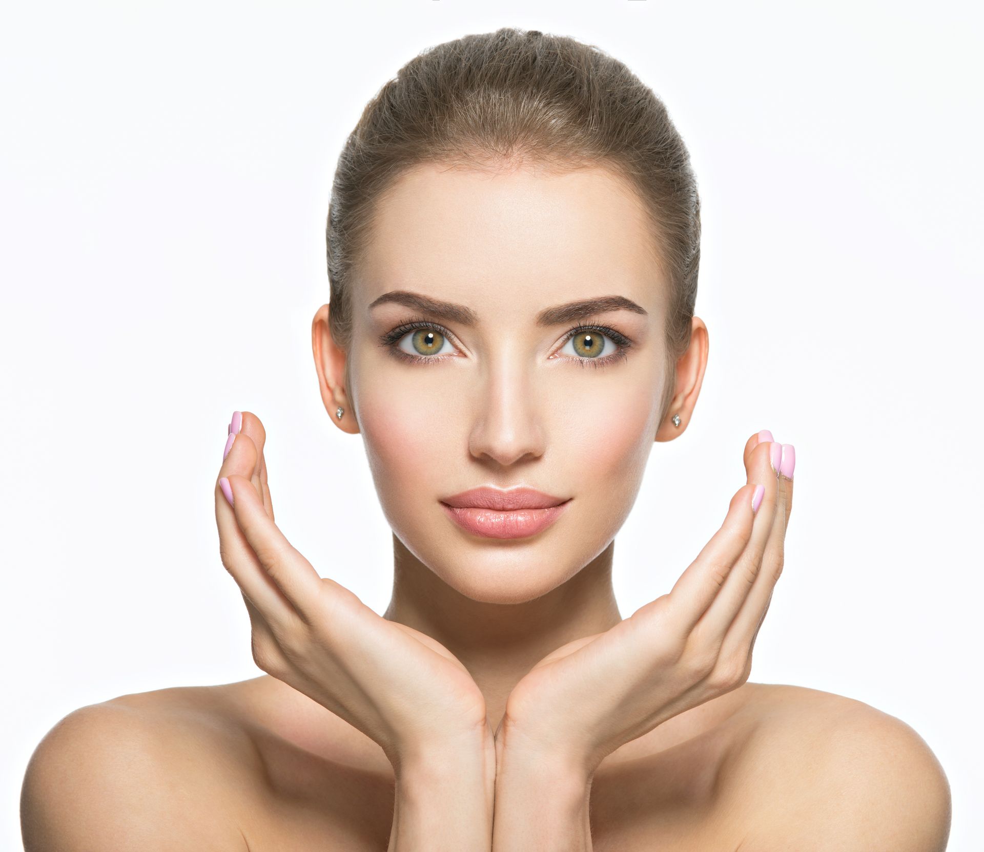 A beautiful young woman is holding her hands to her face.